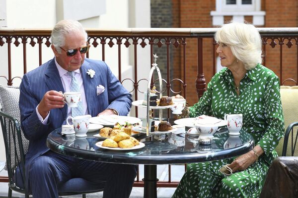Britain's Prince Charles and Camilla, Duchess of Cornwall have afternoon tea on the terrace during a visit to the Theatre Royal Drury Lane, central London, Wednesday June 23, 2021. - Sputnik India