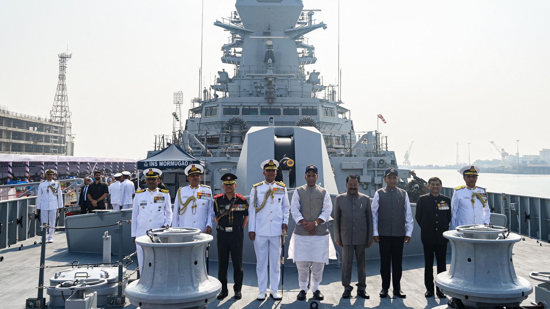 India's Chief of the Naval Staff (CNS) Admiral R. Hari Kumar (4L) and Defence Minister Rajnath Singh (5R) poses with other dignitories after commissioning INS Mormugao, the second stealth guided missile destroyer of Project 15B, into the Indian Navy, at the Naval Dockyard in Mumbai on December 18, 2022 - Sputnik India, 1920, 18.12.2022