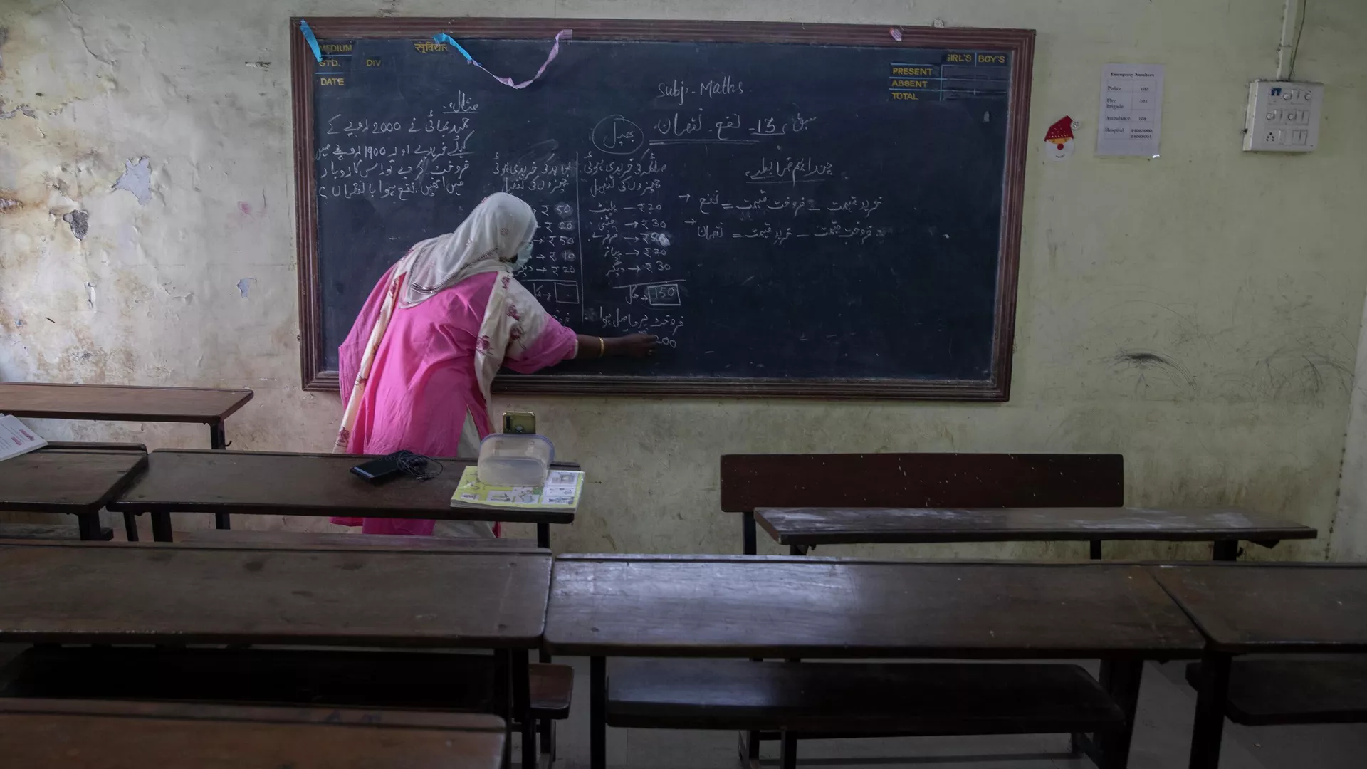 A teacher working at a government school gives an online class inside an empty class room in Dharavi, Asia's largest slum in Mumbai, India, Tuesday, Jan. 4, 2022.