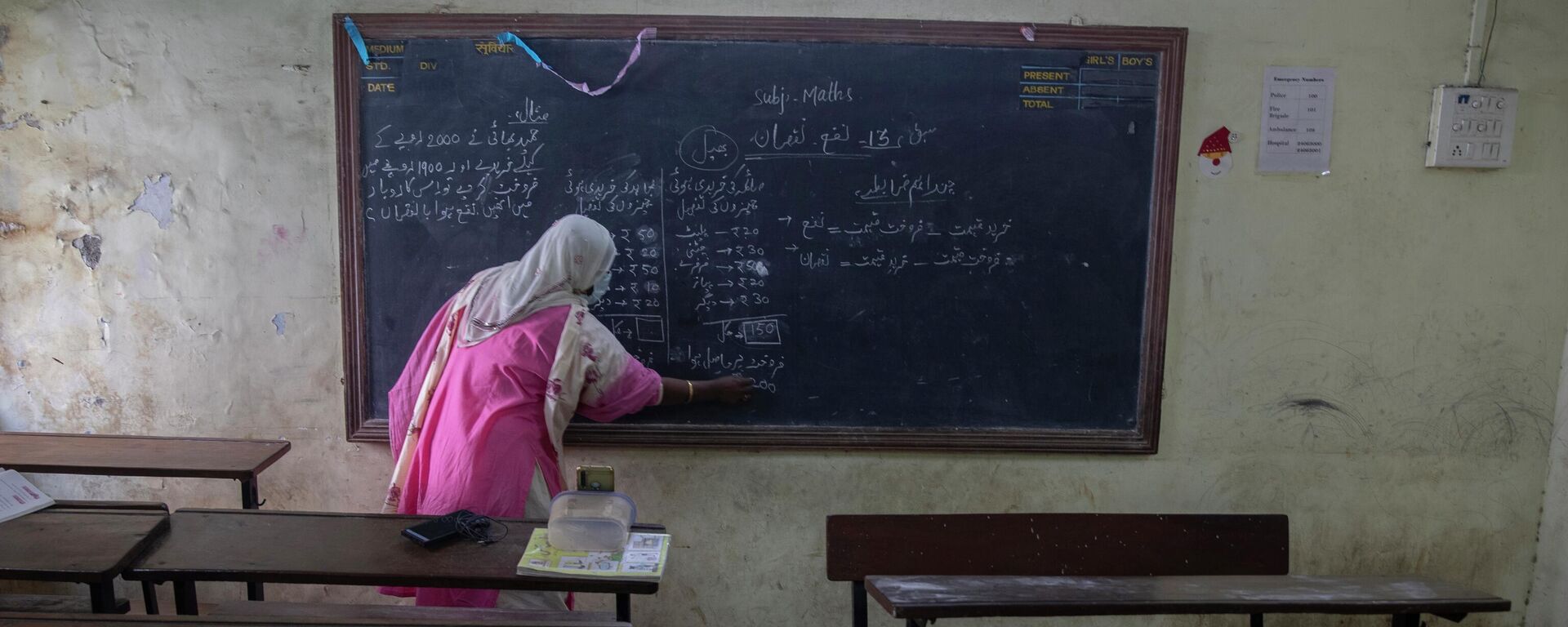 A teacher working at a government school gives an online class inside an empty class room in Dharavi, Asia's largest slum in Mumbai, India, Tuesday, Jan. 4, 2022. - Sputnik भारत, 1920, 02.01.2024