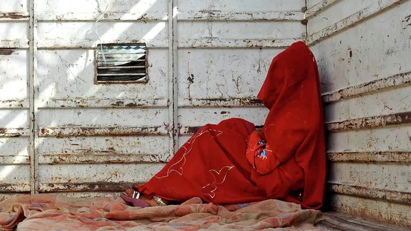 In this May 7, 2011 file photo, 7-year-old child bride sits in the back of a truck as she waits for the rest of her family members after being wed, at Biaora, about 135 kilometers from Bhopal, India. - Sputnik भारत