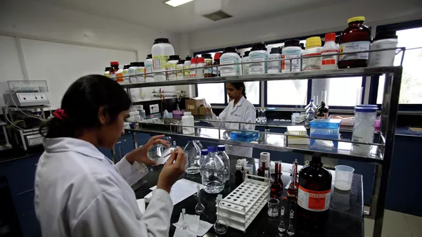 In this March 13, 2012 file photo, Indian scientists work inside a laboratory of the Research and Development Centre of Natco Pharma Ltd. in Hyderabad, India. - Sputnik India