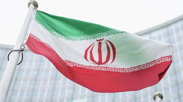 FILE - The flag of Iran waves in front of the the International Center building with the headquarters of the International Atomic Energy Agency, IAEA, in Vienna, AustriaI, May 24, 2021. On Monday, Nov. 29, 2021, negotiators are gathering in Vienna to resume efforts to revive Iran's 2015 nuclear deal with world powers, with hopes of quick progress muted after the arrival of a hard-line new government in Tehran led to a more than five-month hiatus. (AP Photo/Florian Schroetter, FILE) - Sputnik India