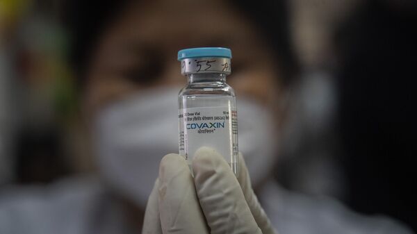 A health worker displays Covaxin COVID-19 vaccine as she prepares to administer the same at a government school in Gauhati, India, Monday, Jan. 3, 2022.  - Sputnik India