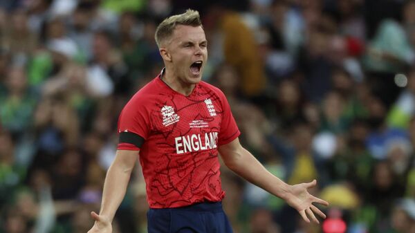England's Sam Curran celebrates the dismissal of Pakistan's Mohammad Rizwan during the final of the T20 World Cup Cricket tournament at the Melbourne Cricket Ground in Melbourne, Australia, Sunday, Nov. 13, 2022. - Sputnik India