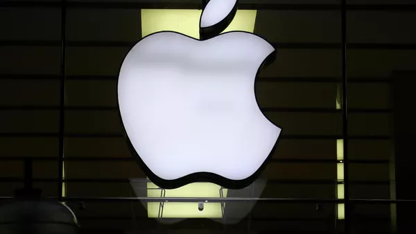 In this Dec. 16, 2020, file photo, the logo of Apple is illuminated at a store in the city center in Munich, Germany.  - Sputnik India