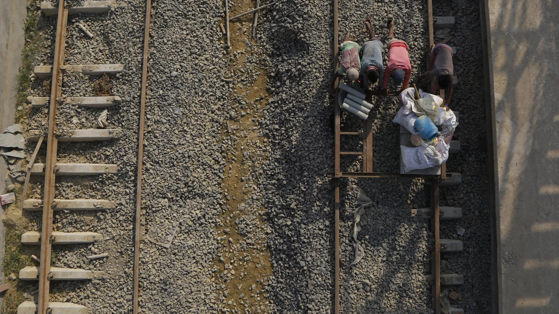 In this Nov. 29, 2018 photo, Nepalese construction laborers work at the terminal train station at Kurtha near Janakpur, Nepal from where a new rail line connects to Jay Nagar in the Indian state of Bihar.