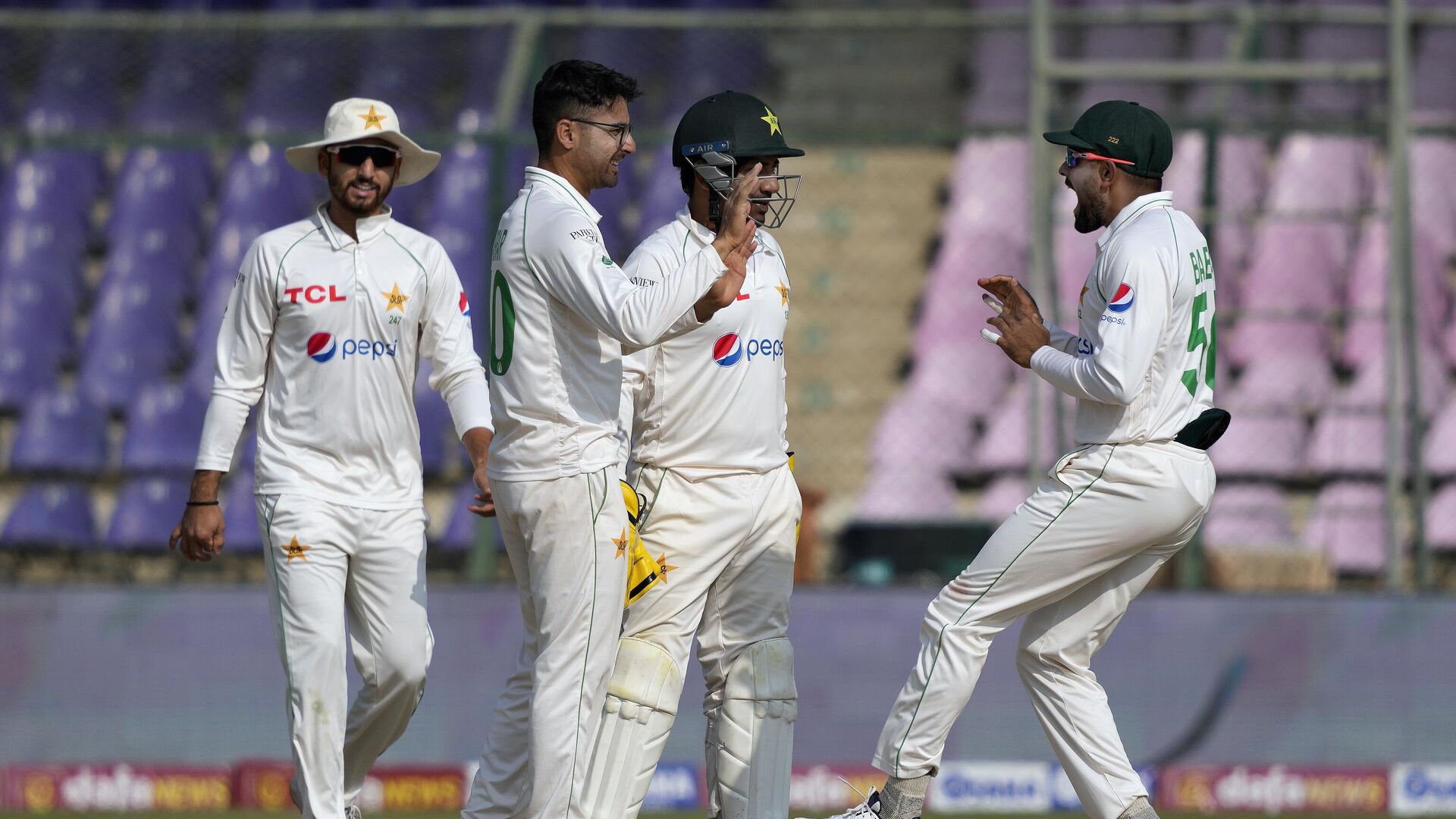 Pakistan's Abrar Ahmed, left, celebrates with teammates after dismissal of New Zealand's Daryl Mitchell during the third day of first test cricket match between Pakistan and New Zealand, in Karachi, Pakistan, Wednesday, Dec. 28, 2022. - Sputnik India, 1920, 28.12.2022