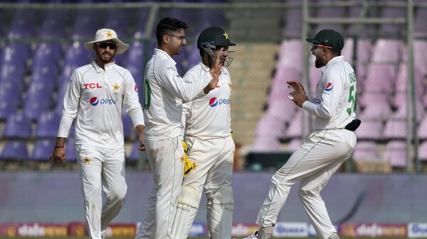 Pakistan's Abrar Ahmed, left, celebrates with teammates after dismissal of New Zealand's Daryl Mitchell during the third day of first test cricket match between Pakistan and New Zealand, in Karachi, Pakistan, Wednesday, Dec. 28, 2022. - Sputnik भारत