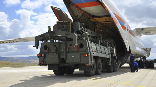 Military vehicles and equipment, parts of the S-400 air defense systems, are unloaded from a Russian transport aircraft, at Murted military airport in Ankara, Turkey, Friday, July 12, 2019 - Sputnik भारत