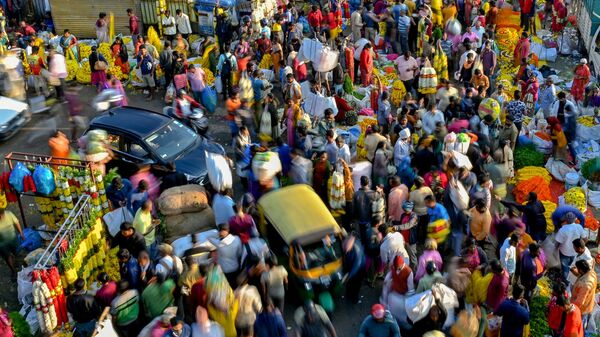 This picture taken on October 23, 2022 shows people walking through a market in Bangalore. - Sputnik India