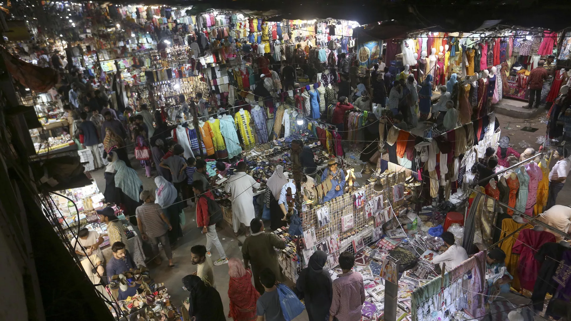People visit a market to shop for the upcoming Eid al-Fitr celebrations, in Karachi, Pakistan, Friday, April 29, 2022. 