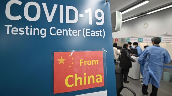 Health workers guide travellers arriving from China at a Covid-19 testing centre at Incheon International Airport, west of Seoul on January 3, 2023 - Sputnik India