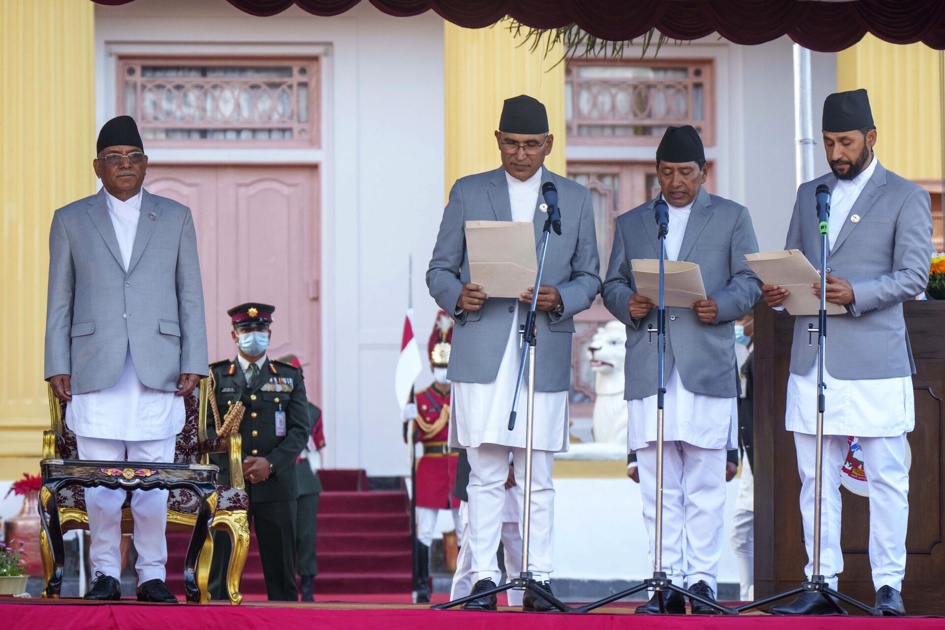 Nepal's newly appointed prime minister Pushpa Kamal Dahal, left, looks on as his deputies, from right, Rabi Lamichhane, Narayan Kaji Shrestha and Bishnu Paudel are being sworn in during a ceremony at the President House during a ceremony in Kathmandu, Nepal, Monday, Dec. 26, 2022. - Sputnik India, 1920, 28.01.2023