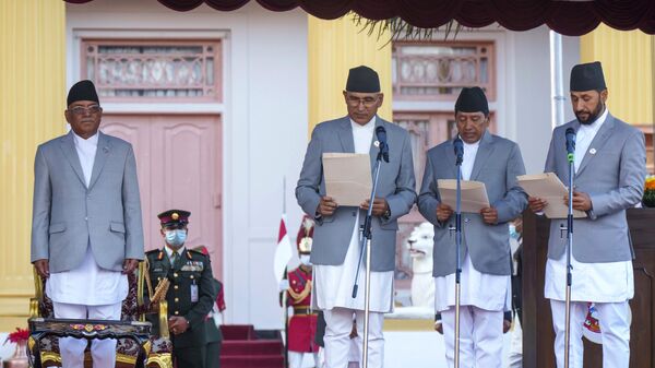 Nepal's newly appointed prime minister Pushpa Kamal Dahal, left, looks on as his deputies, from right, Rabi Lamichhane, Narayan Kaji Shrestha and Bishnu Paudel are being sworn in during a ceremony at the President House during a ceremony in Kathmandu, Nepal, Monday, Dec. 26, 2022. - Sputnik भारत
