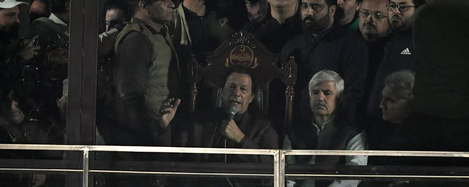 Former Pakistan's Prime Minister Imran Khan (C) delivers a speech behind bullet proof glass shield during an anti-government rally in Rawalpindi on November 26, 2022. - Sputnik India, 1920, 10.01.2023