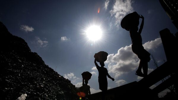 FILE- In this Oct. 20, 2010 file photo, Indian laborers carry coal to load on a truck in Gauhati, India - Sputnik भारत