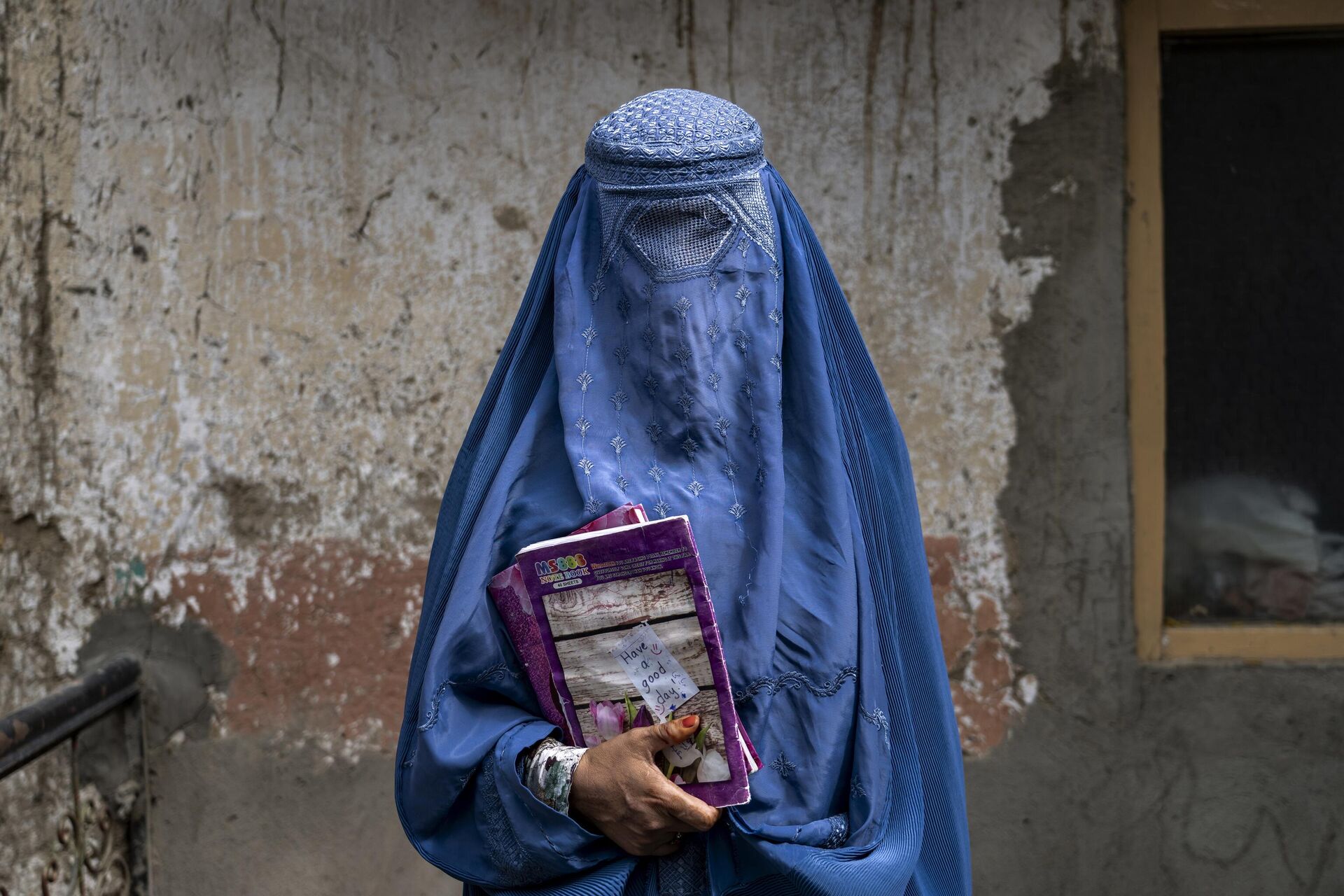 Arefeh 40-year-old, an Afghan woman leaves an underground school, in Kabul, Afghanistan, Saturday, July 30, 2022. - Sputnik India, 1920, 05.12.2023