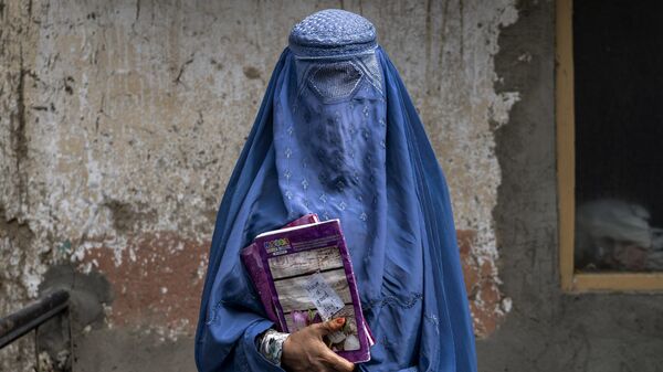 Arefeh 40-year-old, an Afghan woman leaves an underground school, in Kabul, Afghanistan, Saturday, July 30, 2022. - Sputnik India