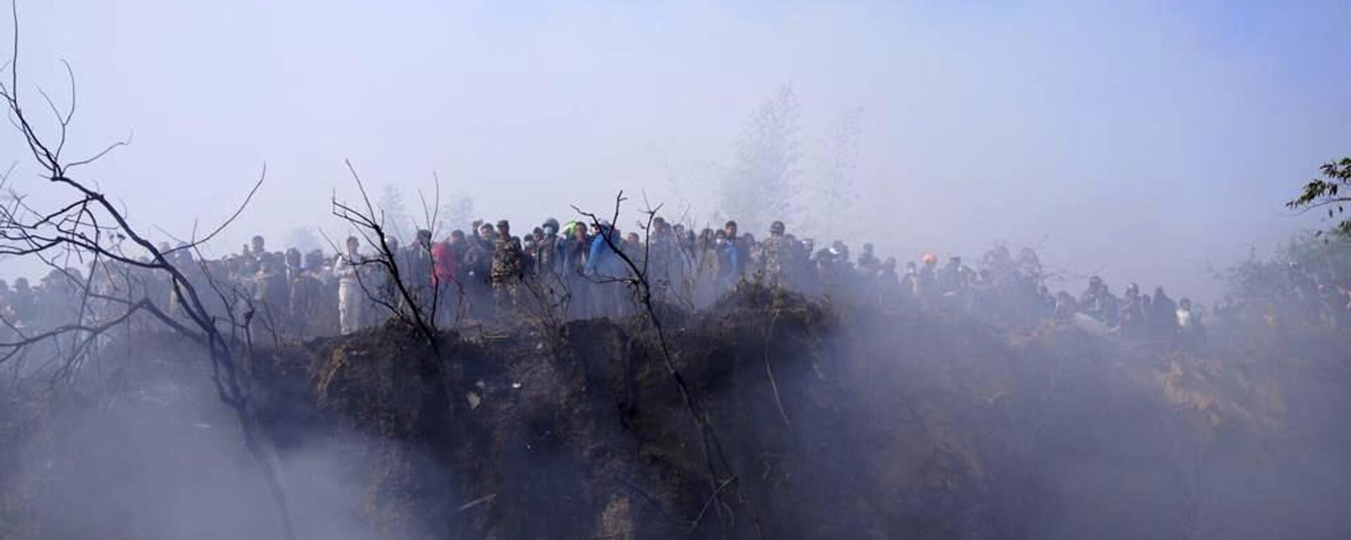 Locals watch the wreckage of a passenger plane in Pokhara, Nepal, Sunday, Jan.15, 2023. - Sputnik India, 1920, 16.01.2023