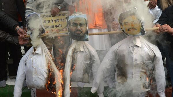 Rashtrawadi Shiv Sena (RSS) leader, Jai Bhagwan Goyal and party activists burn the effigies of underworld don Dawood Ibrahim, who is wanted for the 1993 Mumbai bombings, (R), Pakistan chief of Jamaat-ud-Dawa, Hafiz Muhammad Saeed (C) and a leader of Lashkar-e-Taiba and 2008 Mumbai attacks accused, Zaki-ur-Rehman Lakhvi during a protest in New Delhi on December 21, 2014. - Sputnik भारत