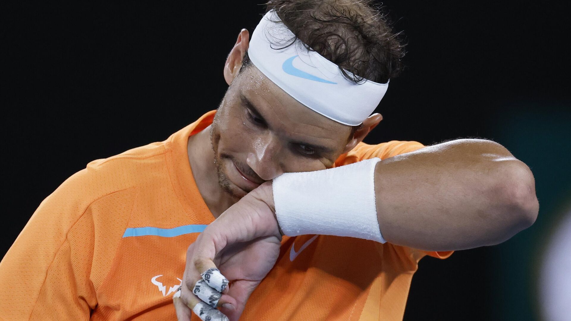 Rafael Nadal of Spain wipes the sweat from his face during his second round match against Mackenzie McDonald of the U.S., at the Australian Open tennis championship in Melbourne, Australia, Wednesday, Jan. 18, 2023. - Sputnik India, 1920, 18.01.2023