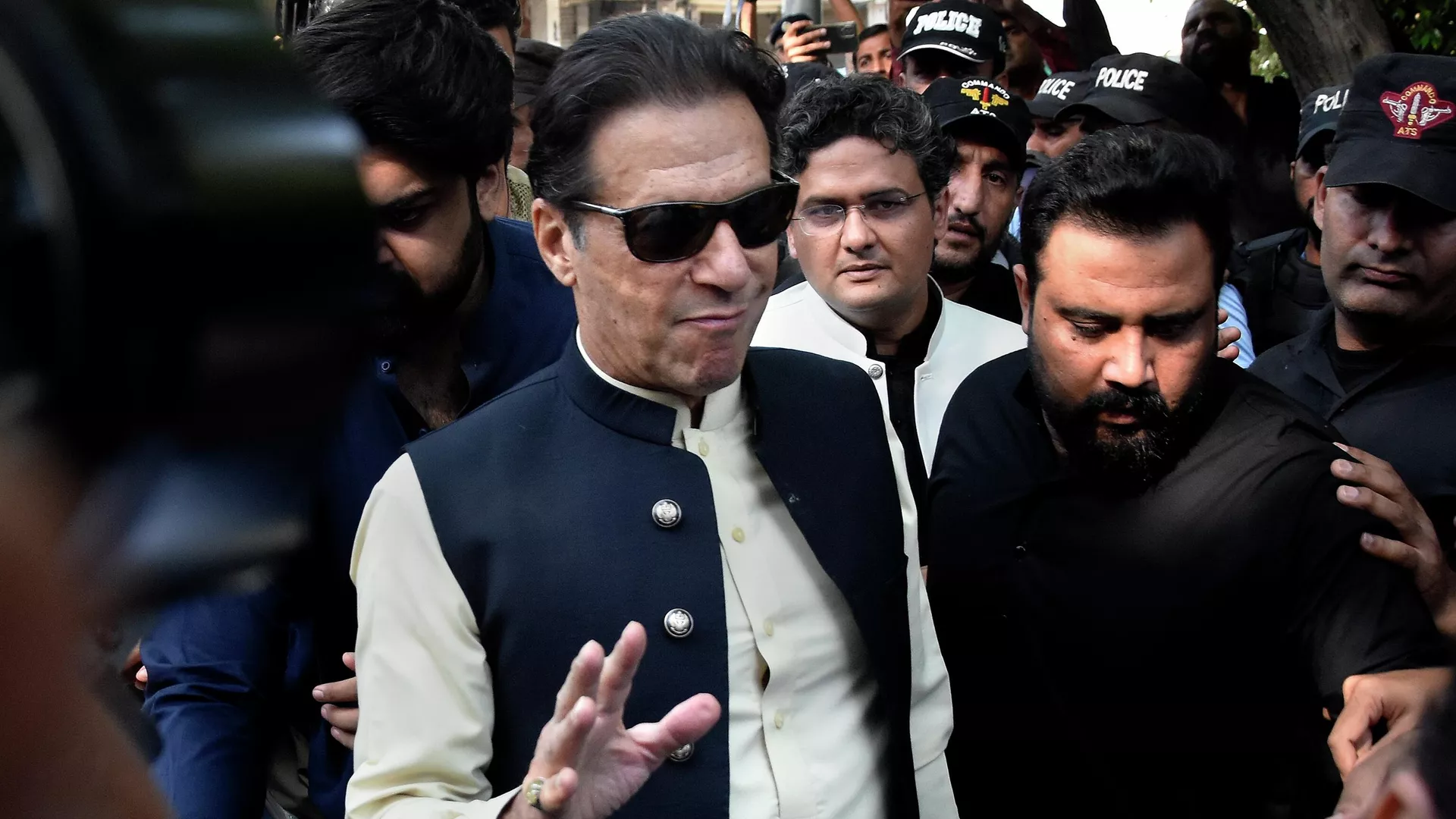 Former Pakistani Prime Minister Imran Khan, center, arrives to the Islamabad High Court surrounded by security, in Islamabad, Pakistan, Monday, Oct. 3, 2022.