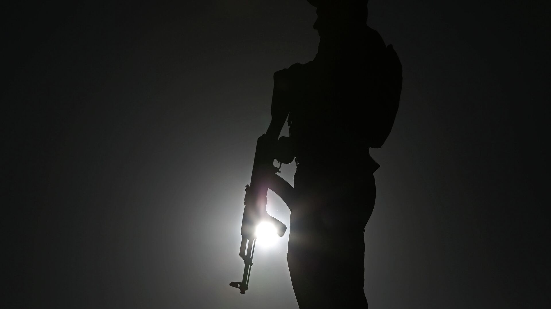 An Afghan police officer stands guard during a campaign rally in the Paghman district of Kabul, Afghanistan, Monday, June 9, 2014.  - Sputnik India, 1920, 04.02.2023