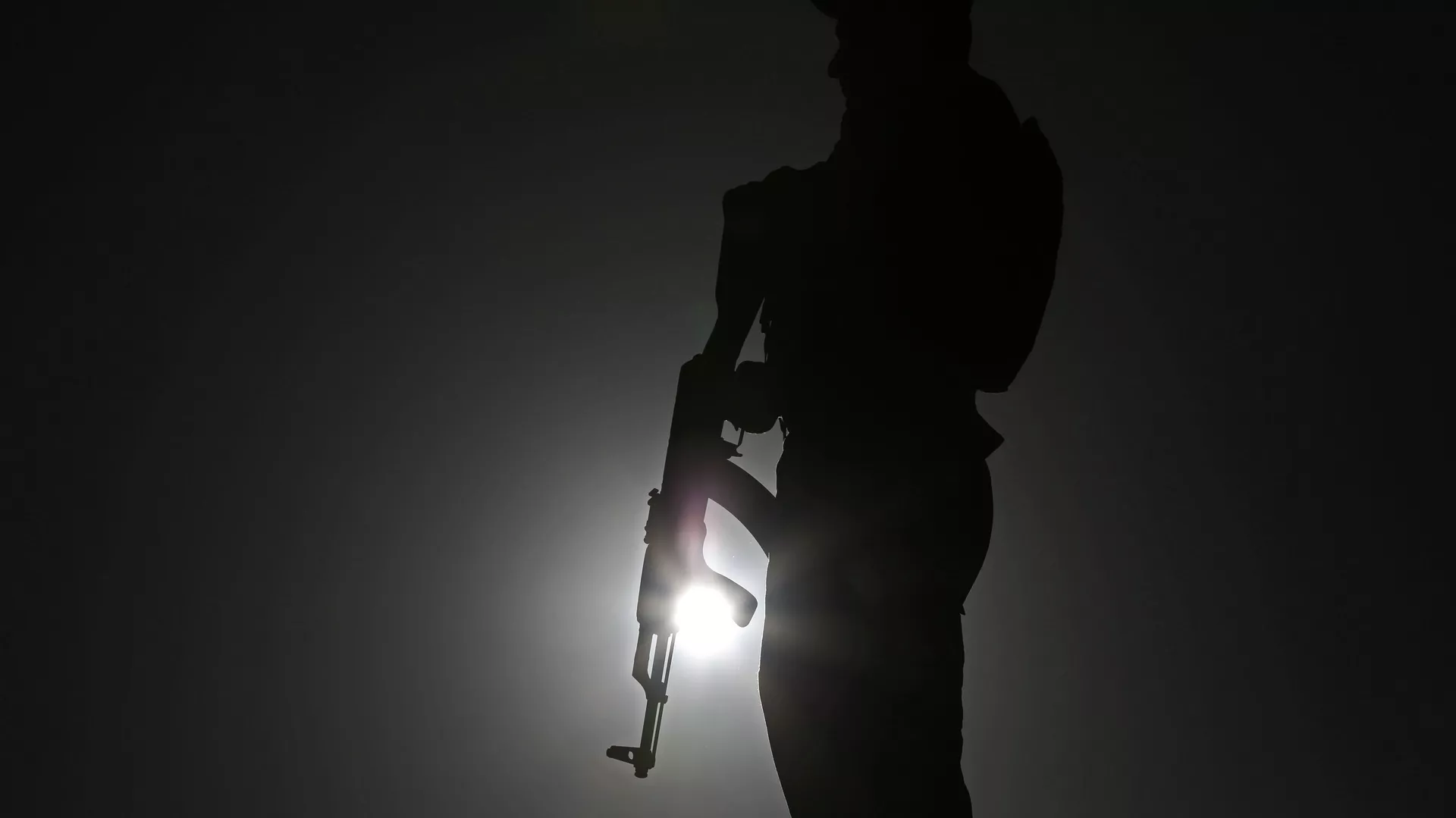 An Afghan police officer stands guard during a campaign rally in the Paghman district of Kabul, Afghanistan, Monday, June 9, 2014. 