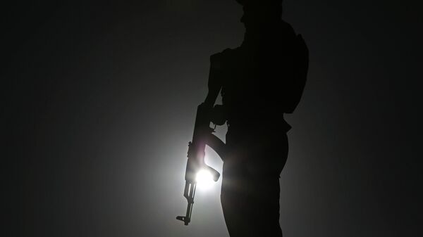 An Afghan police officer stands guard during a campaign rally in the Paghman district of Kabul, Afghanistan, Monday, June 9, 2014.  - Sputnik India