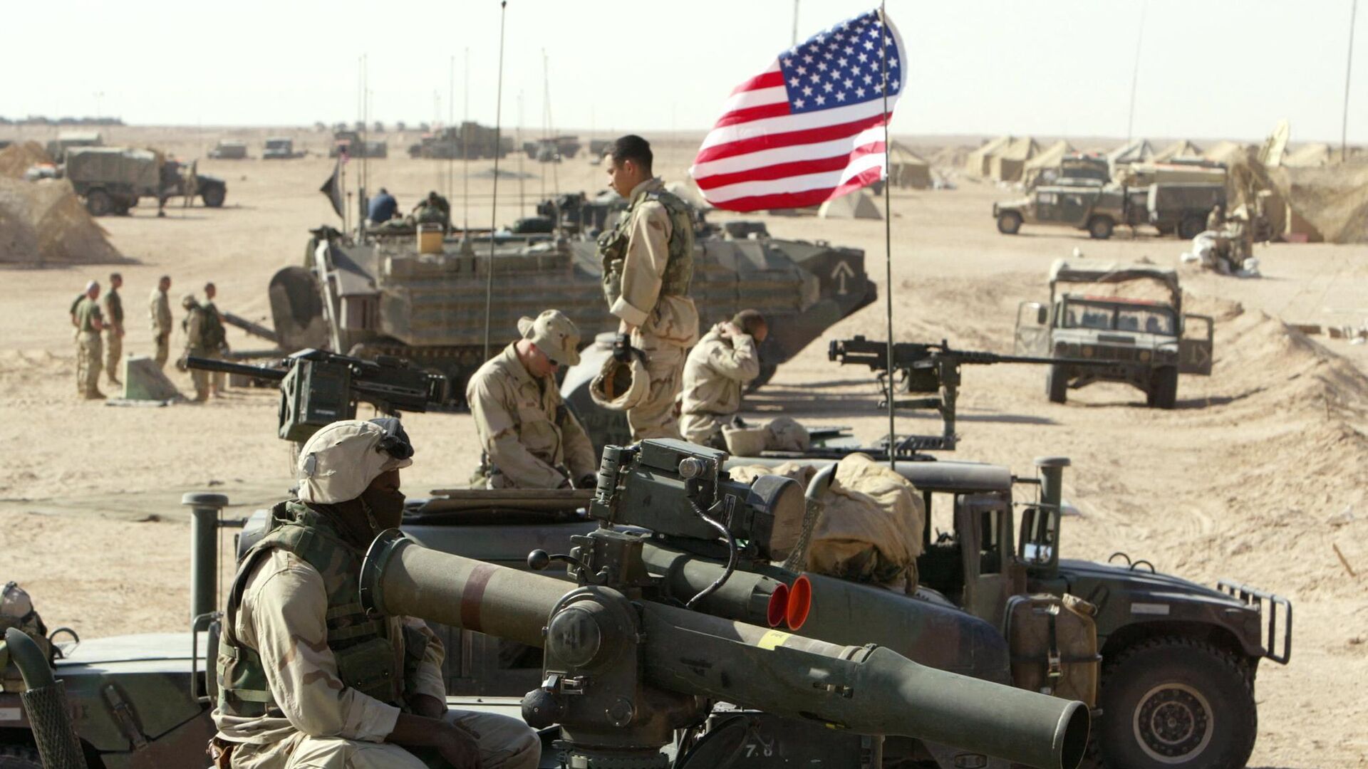 American marines of the USMC (US Marine Corps) put a flag on a antenna of a HMMWI (Hight Mobility Multi Wheeled Vehicles)  in the north of the desert Kuwait near the Iraqi border 15 March 2003. - Sputnik India, 1920, 05.02.2023