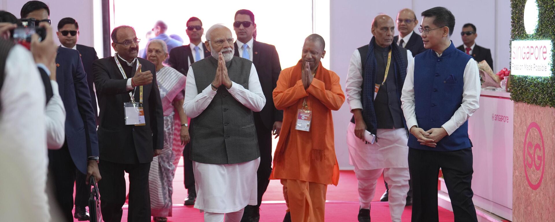 Indian Prime Minister Narendra Modi, centre, is flanked by Uttar Pradesh state Chief Minister Yogi Adityanath, in saffron dress, as they visit stalls during global investors summit in Lucknow, India. Friday, Feb. 10, 2023.  - Sputnik India, 1920, 10.02.2023