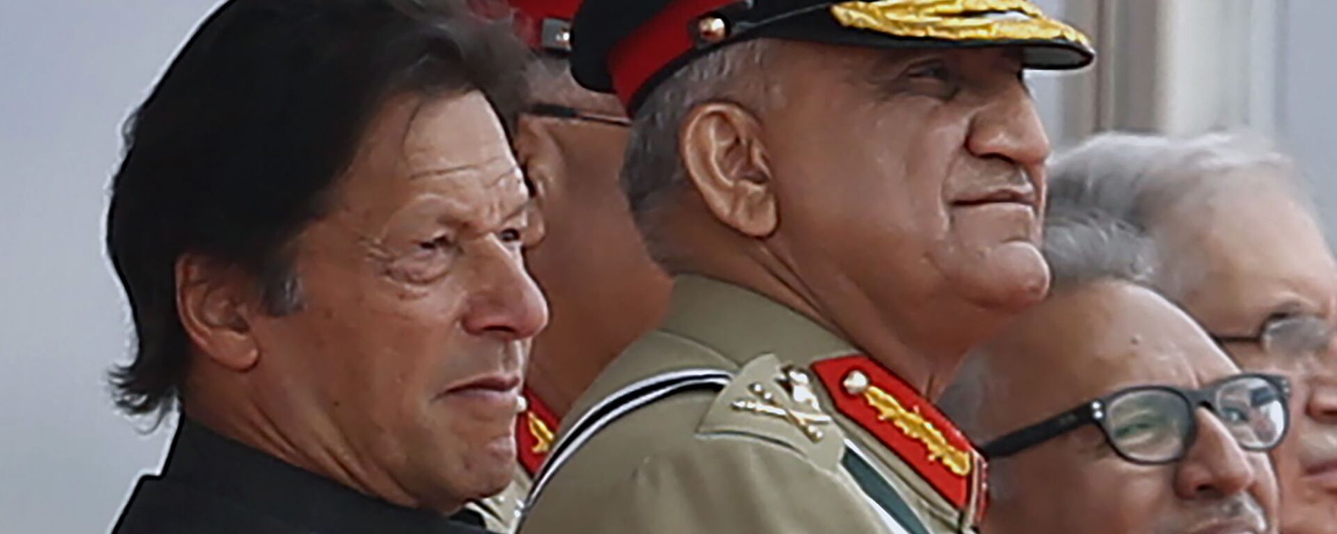 In this March 23, 2019 photo, Pakistan's Army Chief Gen. Qamar Javed Bajwa, center, watches a parade with Prime Minister Imran Khan, left, and President Arif Alvi, in Islamabad, Pakistan.  - Sputnik India, 1920, 07.02.2024