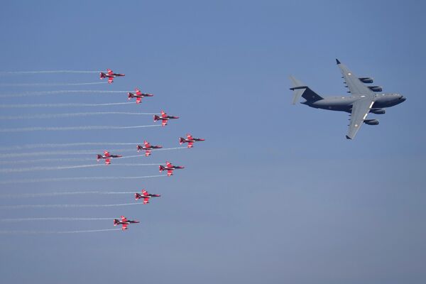 Indian Air Force C-17 Globemaster leads nine Suryakiran aircraft as they fly in a formation during rehearsals ahead of the Aero India 2023 at Yelahanka air base in Bengaluru, India, Saturday, Feb. 11, 2023. - Sputnik India