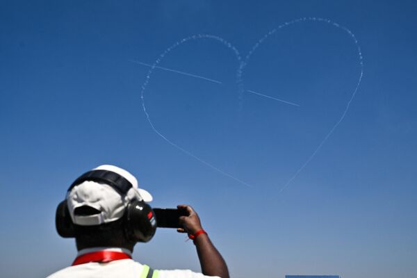 The Indian Air Force (IAF) Surya Kiran aerobatics team performs during the inaugural day of the 14th edition of 'Aero India 2023' airshow at the Yelahanka air force station in Bengaluru on February 13, 2023. - Sputnik India