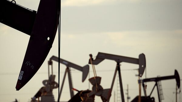 In this April 24, 2015 file photo, pumpjacks work in a field near Lovington, N.M. The United States may have reclaimed the title of the world's biggest oil producer sooner than expected - Sputnik भारत