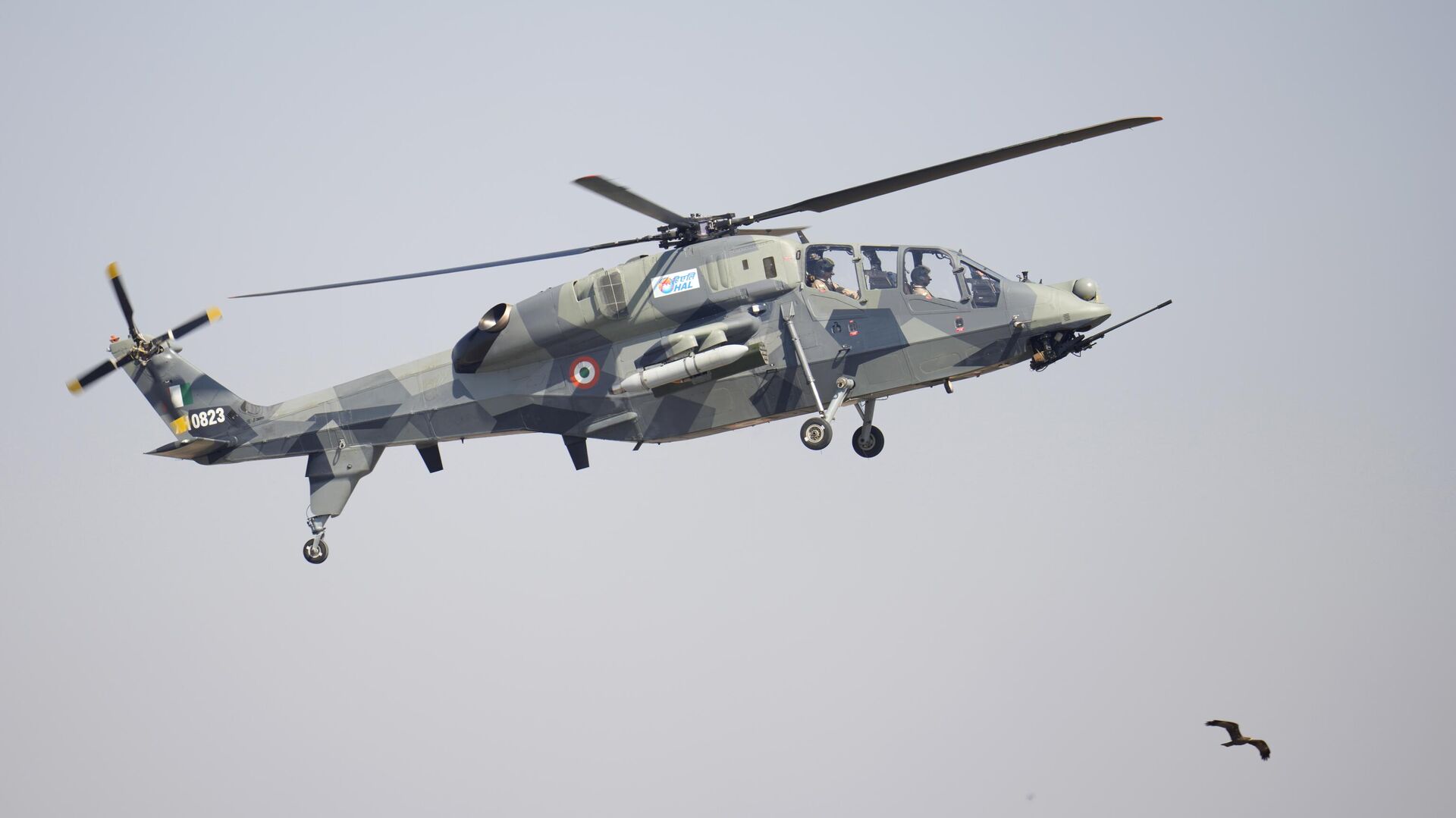 India's indigenous light combat helicopter Prachand flies over a bird during the inauguration of the Aero India 2023 at Yelahanka air base in Bengaluru, India, Monday, Feb. 13, 2023. - Sputnik India, 1920, 16.02.2023