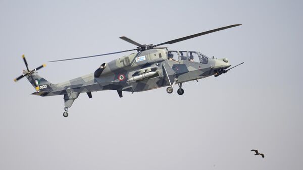 India's indigenous light combat helicopter Prachand flies over a bird during the inauguration of the Aero India 2023 at Yelahanka air base in Bengaluru, India, Monday, Feb. 13, 2023. - Sputnik India