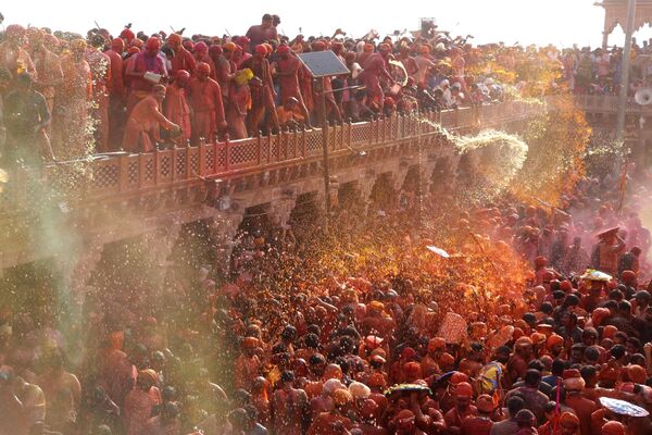 In this photograph taken on March 1, 2023, Hindu devotees celebrate Holi, the spring festival of colours, during a traditional gathering at a temple in Nandgaon village of India&#x27;s Uttar Pradesh state. - Sputnik India