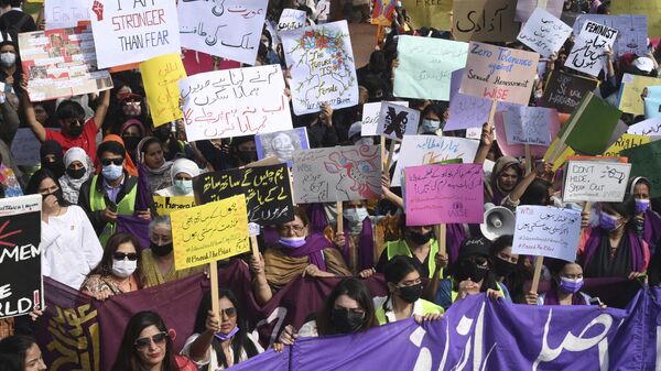 Aurat March activists hold placards as they gather during a demonstration to mark the International Women's Day in Lahore on March 8, 2022. - Sputnik India