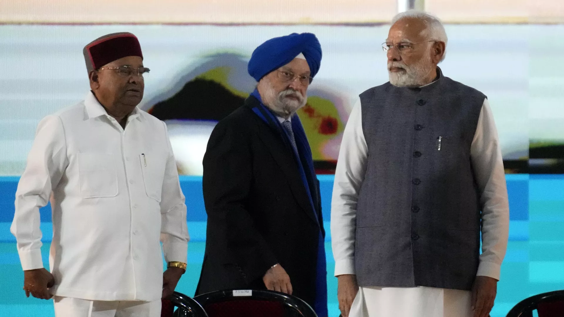 Indian Prime Minister Narendra Modi, right, watches as his colleague and minister for petroleum and natural gas Hardeep Singh Puri, center, walks to address a gathering at the 'India Energy Week 2023' in Bengaluru, India, Monday, Feb. 6, 2023.