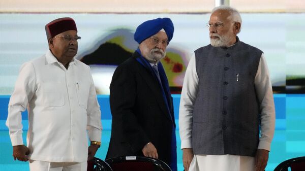 Indian Prime Minister Narendra Modi, right, watches as his colleague and minister for petroleum and natural gas Hardeep Singh Puri, center, walks to address a gathering at the 'India Energy Week 2023' in Bengaluru, India, Monday, Feb. 6, 2023. - Sputnik India
