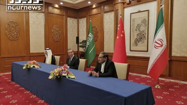 In this photo released by Nournews, Secretary of Iran's Supreme National Security Council, Ali Shamkhani, right, China's most senior diplomat Wang Yi, center, and Saudi Arabia's National Security Adviser Musaad bin Mohammed al-Aiban looks on during an agreement signing ceremony between Iran and Saudi Arabia to reestablish diplomatic relations and reopen embassies after seven years of tensions between the Mideast rivals, in Beijing, China, Friday, March 10, 2023. - Sputnik India