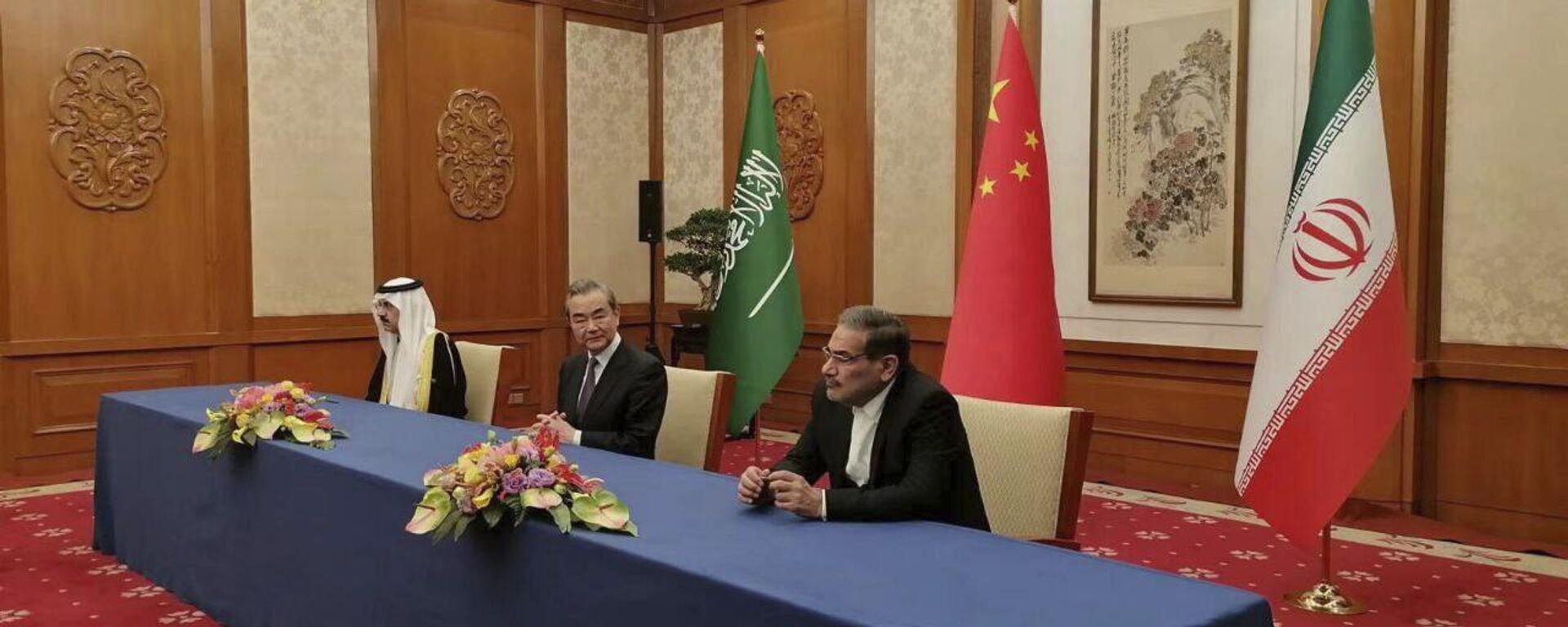 In this photo released by Nournews, Secretary of Iran's Supreme National Security Council, Ali Shamkhani, right, China's most senior diplomat Wang Yi, center, and Saudi Arabia's National Security Adviser Musaad bin Mohammed al-Aiban looks on during an agreement signing ceremony between Iran and Saudi Arabia to reestablish diplomatic relations and reopen embassies after seven years of tensions between the Mideast rivals, in Beijing, China, Friday, March 10, 2023. - Sputnik India, 1920, 18.03.2023