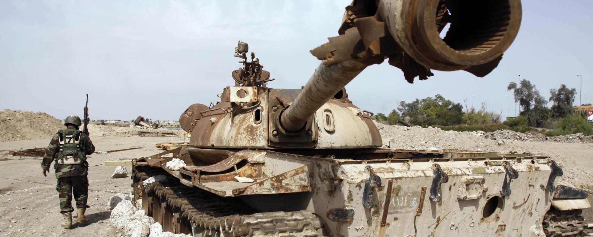 An Iraqi soldier is seen near an Iraqi Army tank, which was destroyed in the US-led invasion, in Basra, Iraq's second-largest city, 550 kilometers (340 miles) southeast of Baghdad, Iraq, Thursday, April 9, 2009 - Sputnik भारत, 1920, 21.03.2023