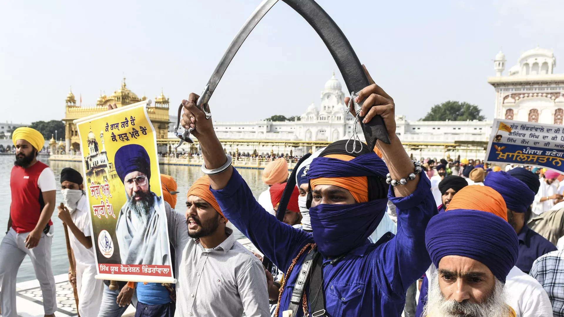 Activists of Sikh organisations hold swords as they shout pro-Khalistan and anti-government slogans after offering prayers on the occasion of the 37th anniversary of Operation Blue Star, at the Golden Temple in Amritsar on June 6, 2021.