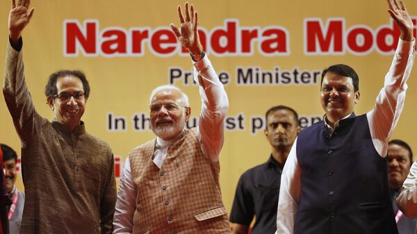 Indian Prime Minister Narendra Modi , center, along with Maharashtra state Chief Minister Devendra Fadnavis, right, and Shiv Sena party chief Uddhav Thackeray wave to the gathering during the inauguration of the first coach for Mumbai Metro built under the 'Make in India' program, and three metro lines In Mumbai, India, Saturday, Sept. 7, 2019. - Sputnik India