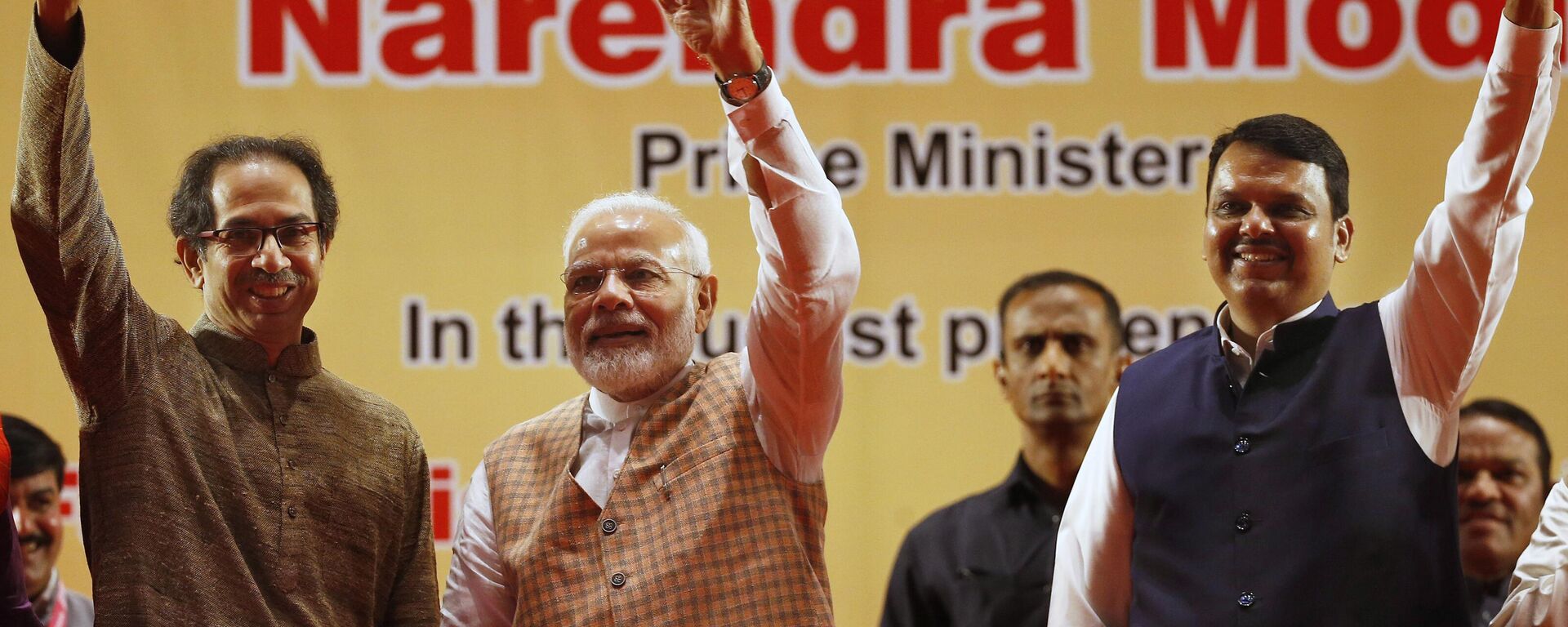 Indian Prime Minister Narendra Modi , center, along with Maharashtra state Chief Minister Devendra Fadnavis, right, and Shiv Sena party chief Uddhav Thackeray wave to the gathering during the inauguration of the first coach for Mumbai Metro built under the 'Make in India' program, and three metro lines In Mumbai, India, Saturday, Sept. 7, 2019. - Sputnik India, 1920, 24.03.2023