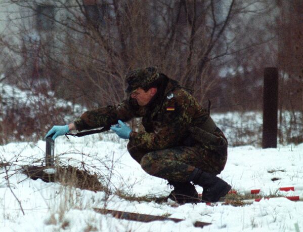 File photo of unidentified German NATO-led soldier measuring radioactivity at former Bosnian Serb army factory which was bombed by 30 mm depleted uranium shells, in Sarajevo suburb of Hadzici. - Sputnik भारत