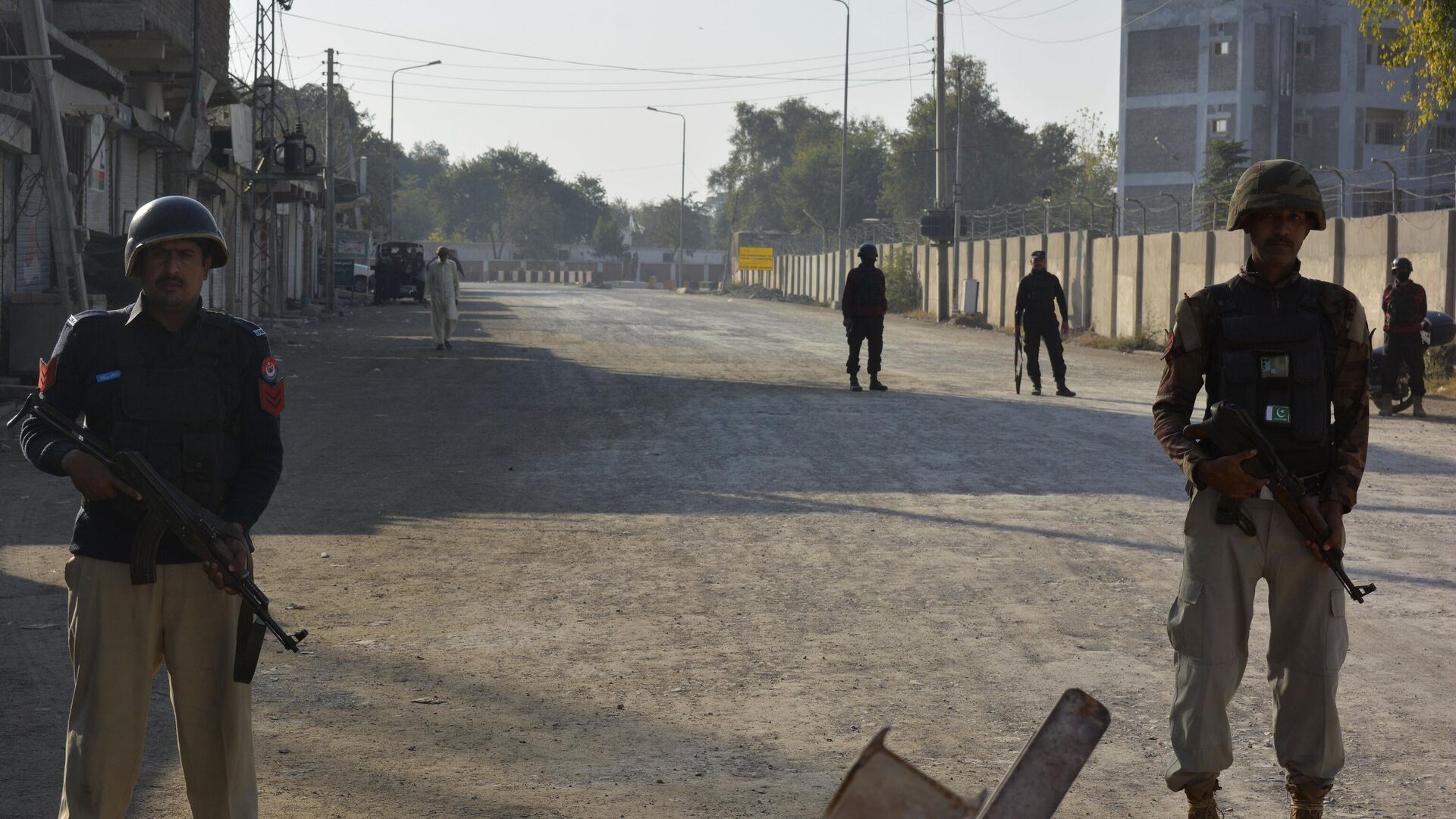 Security officials guard a blocked road leading to a counter-terrorism center after security forces starting to clear the compound seized earlier by Pakistani Taliban militants in Bannu, a northern district in the Pakistan's Khyber Pakhtunkhwa province, Tuesday, Dec. 20, 2022. - Sputnik India, 1920, 05.05.2023